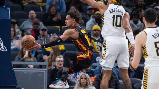 Mar 28, 2022; Indianapolis, Indiana, USA; Atlanta Hawks guard Trae Young (11) passes the ball while Indiana Pacers forward Justin Anderson (10) defends in the second half at Gainbridge Fieldhouse.